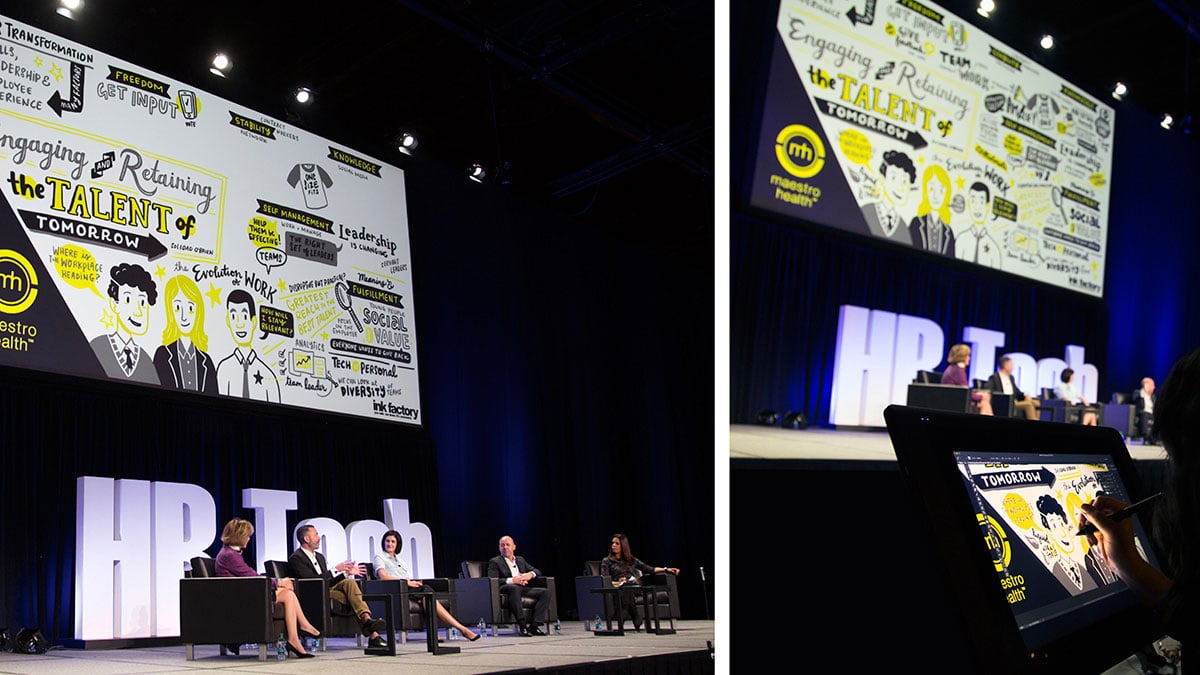 A panel discussion live on stage while an artist creates digital visual notes on screen
